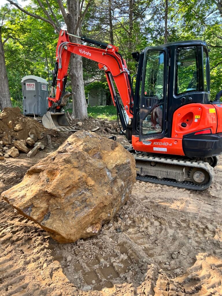 Excavator with boulder